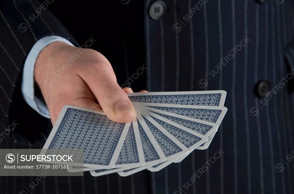 Male holding playing cards