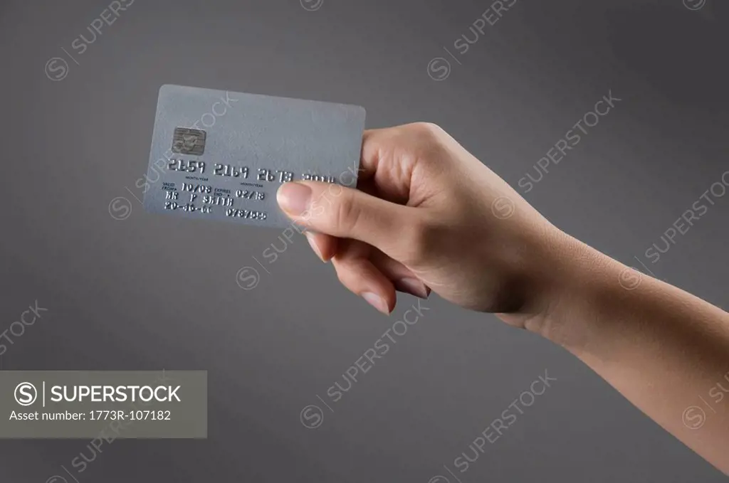 Female hand holding credit card