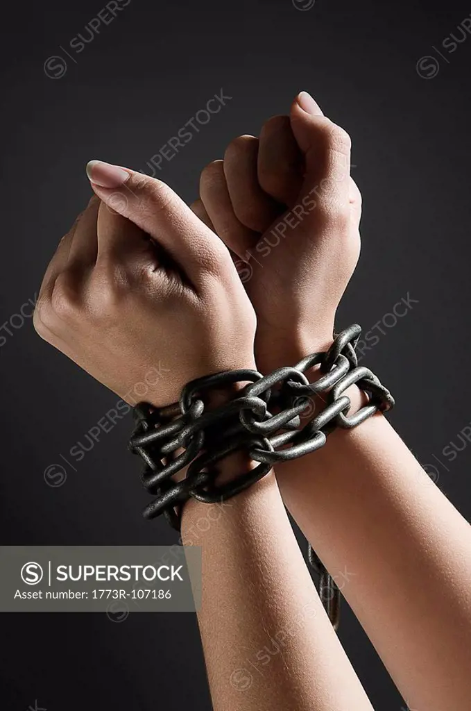 Female hands chained together