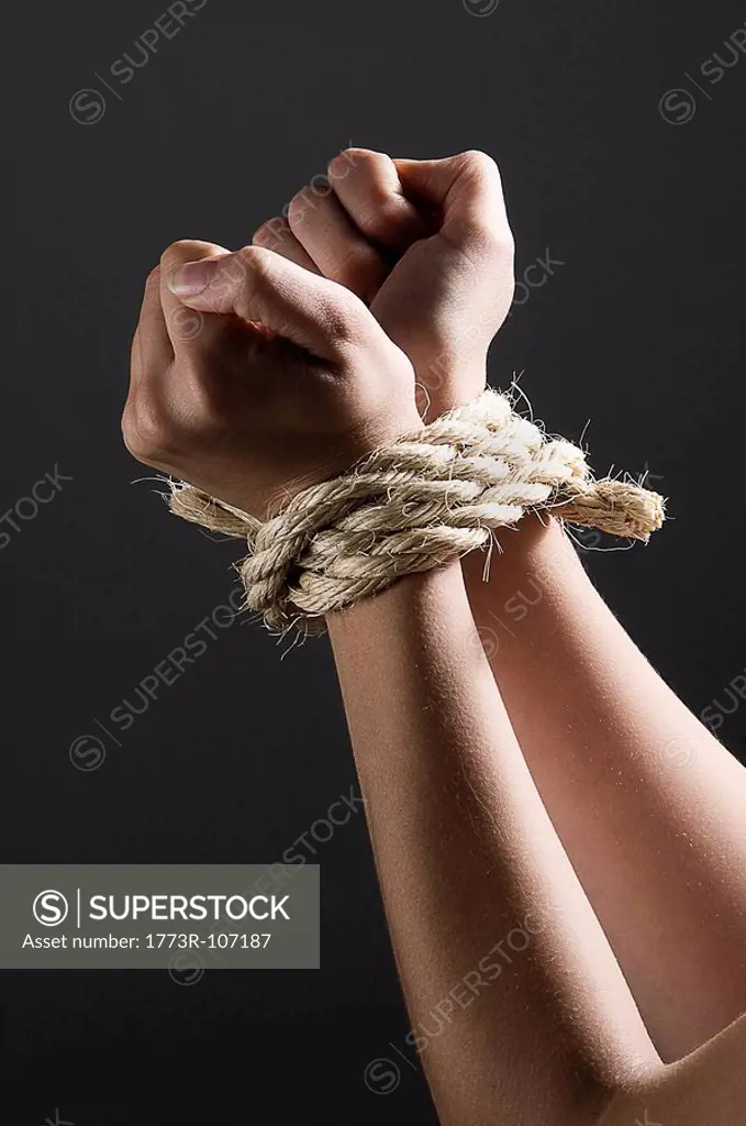 Female hands tied together