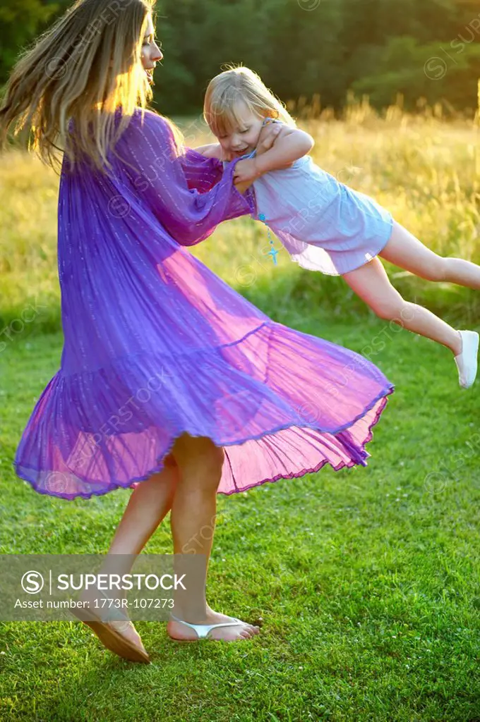 Girl and woman dancing, outdoors