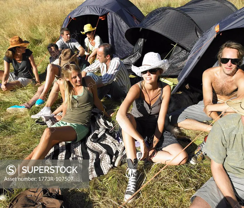 People in a field, backpacking tents