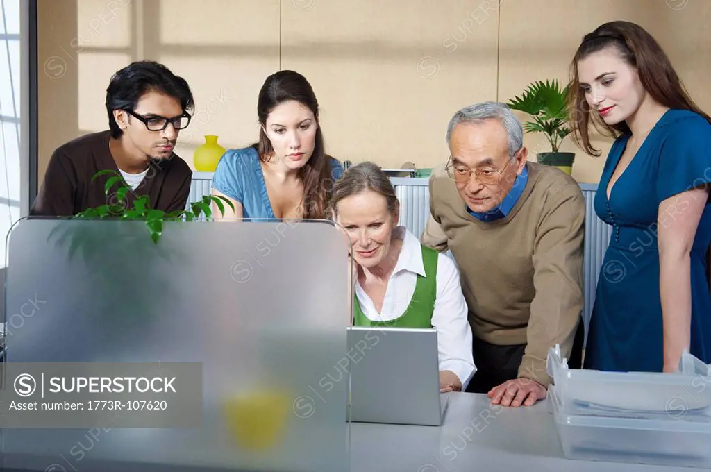 Group of people in front of laptop