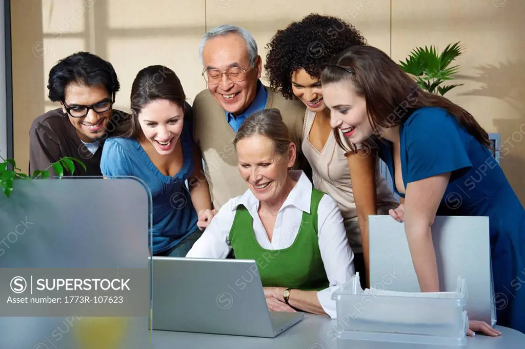 Group of people looking at laptop