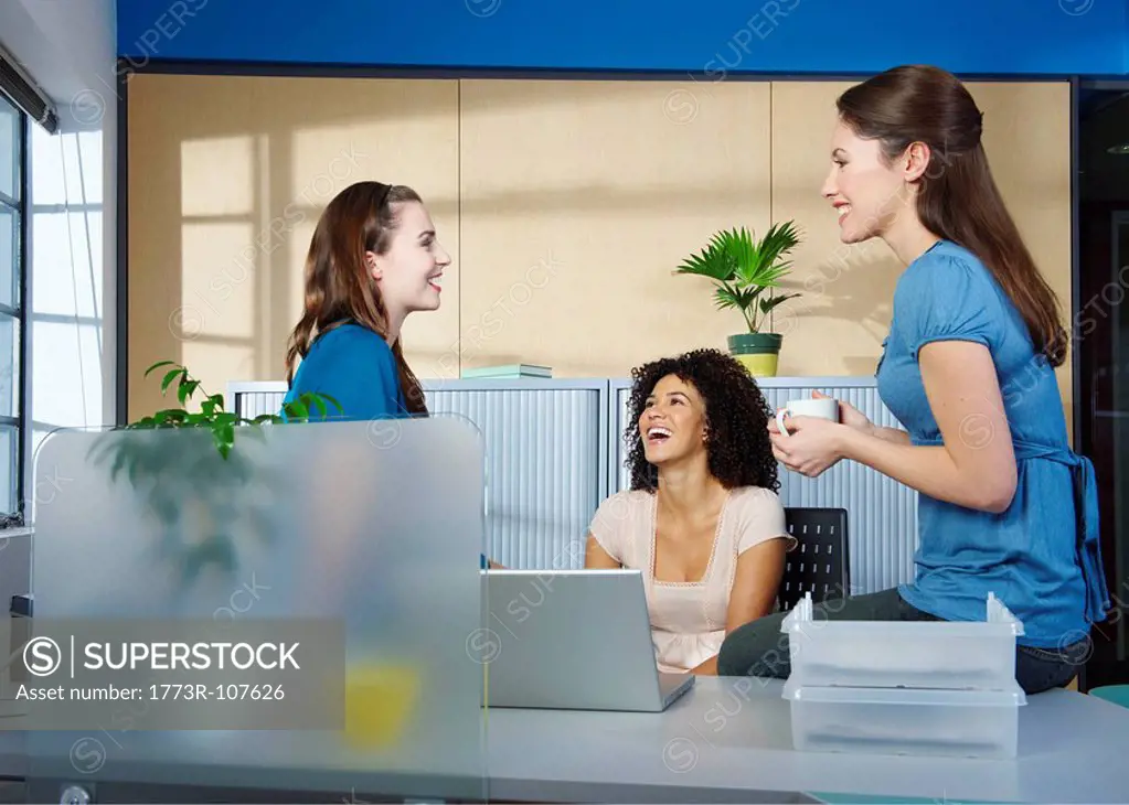 Group of young women at desk in office