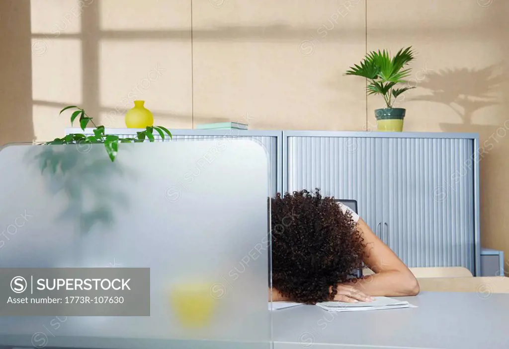 Woman asleep at desk in office