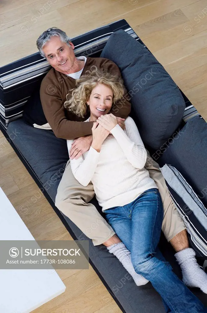Man and woman relaxing on sofa
