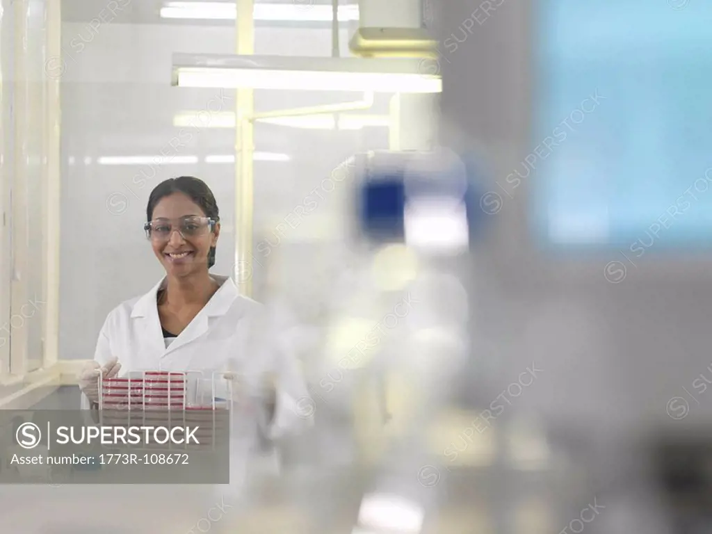 Laboratory technician with petri dishes