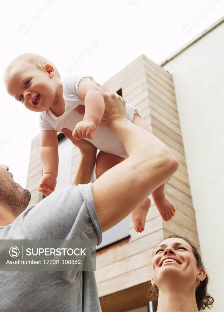 Father holding baby in the air