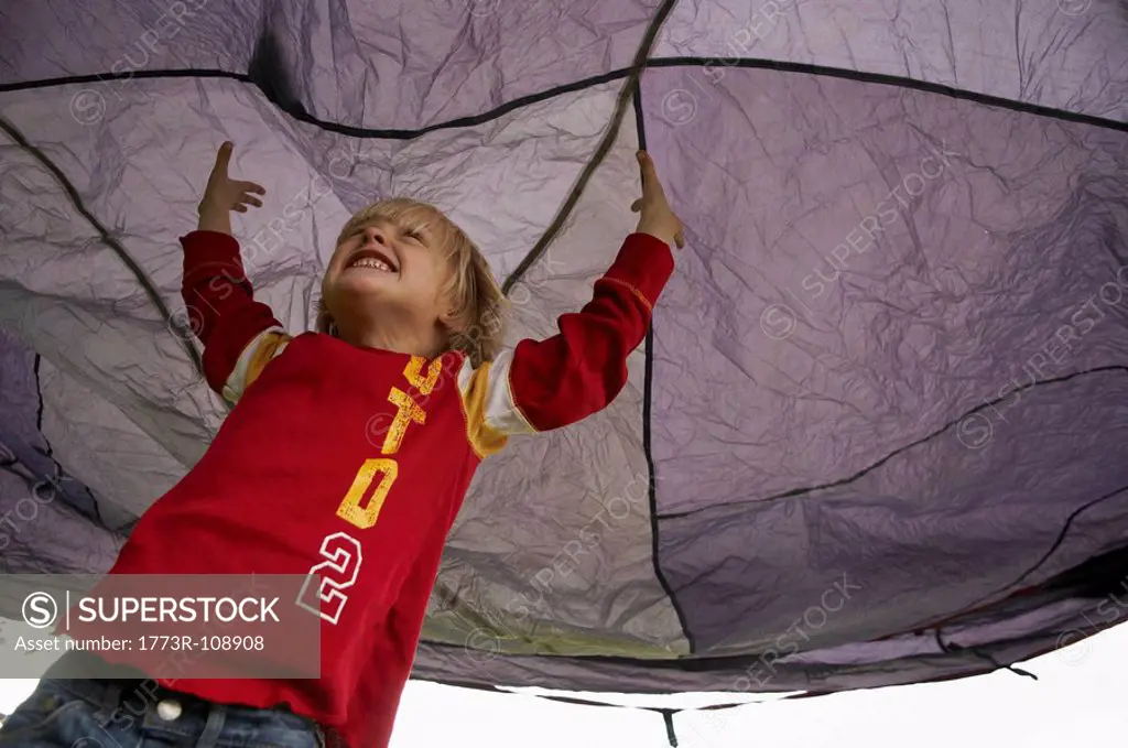 Boy playing under tent