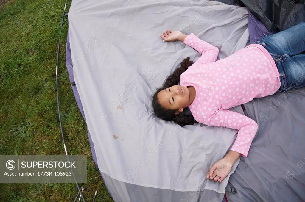 Girl resting on tent
