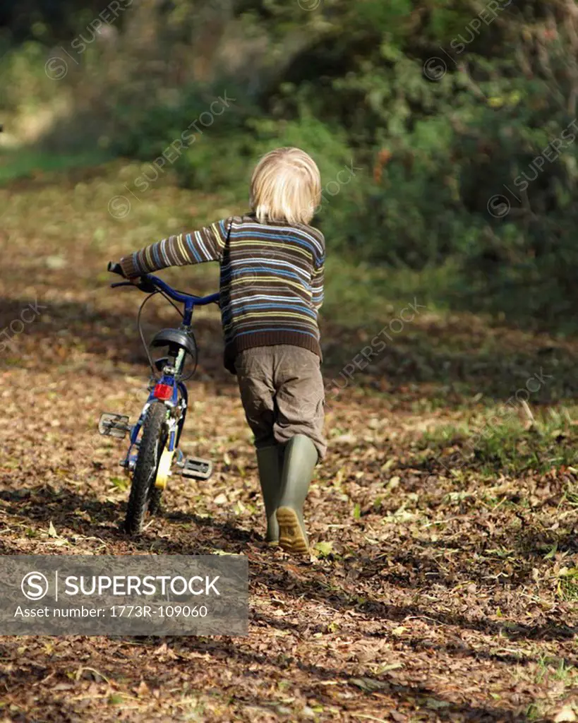 Boy riding bike in countryside