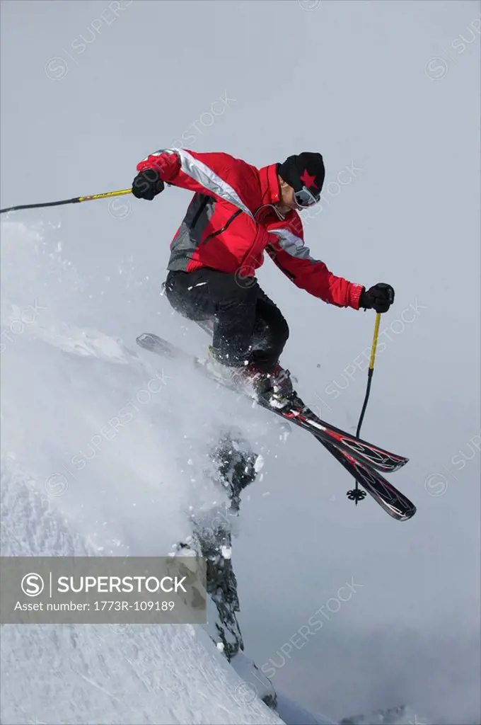 Skier jumping of a rock