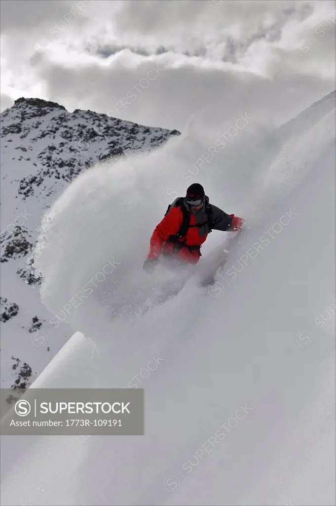 Snowboarder riding in deep snow