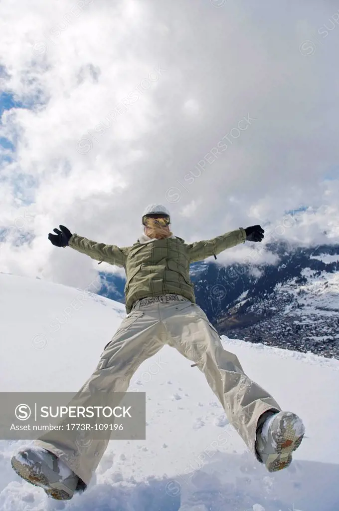 Female snowboarder walking with her snow