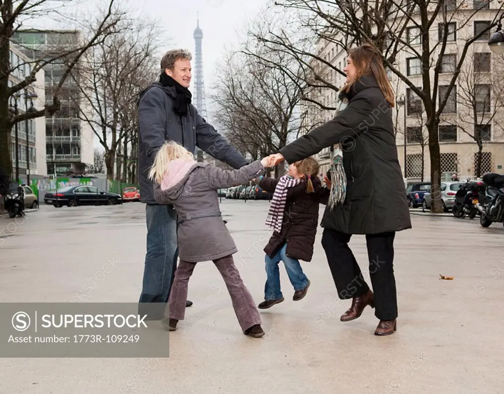 Family dancing near Eiffel Tower