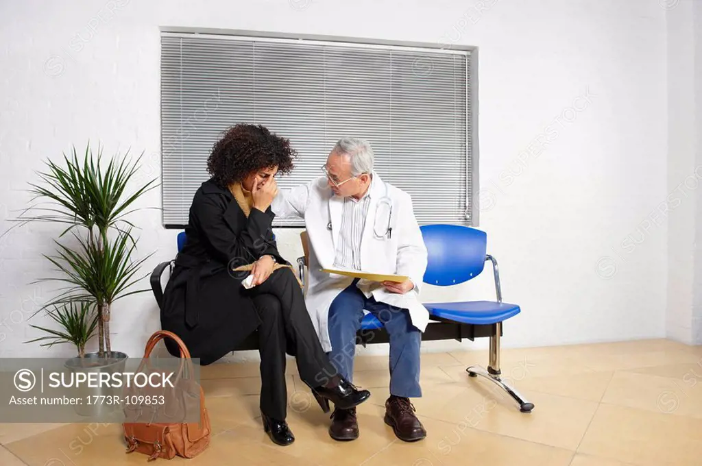 Young woman talking to doctor