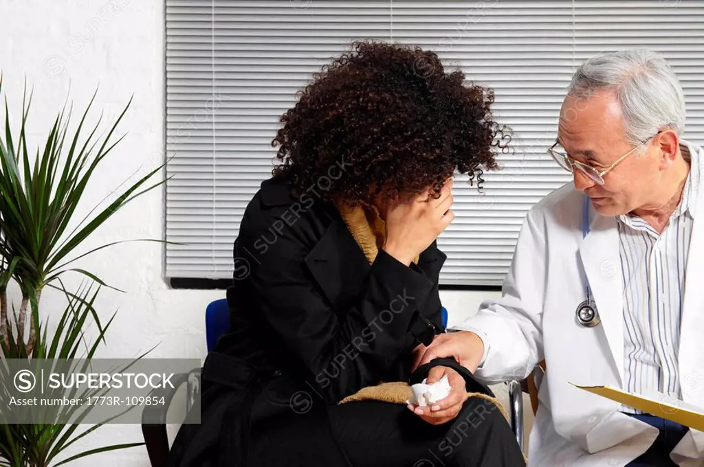 Young woman talking to doctor