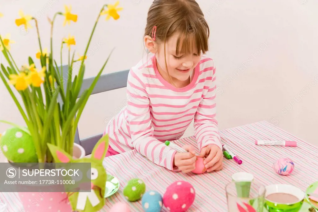 girl painting eggs for easter