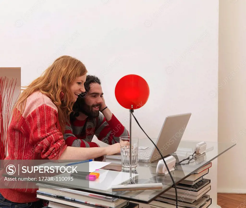 Couple on laptop, using credit card
