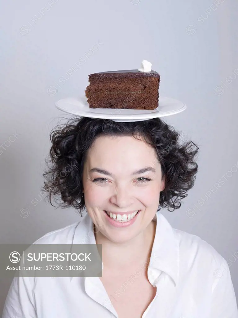 woman with a plate of cake on her head