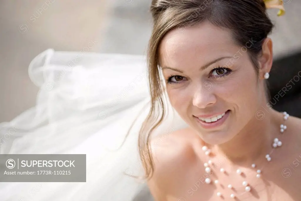 Bride smiling at a camera.
