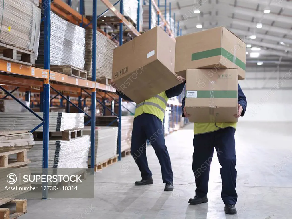 Men Struggling With Boxes In Warehouse