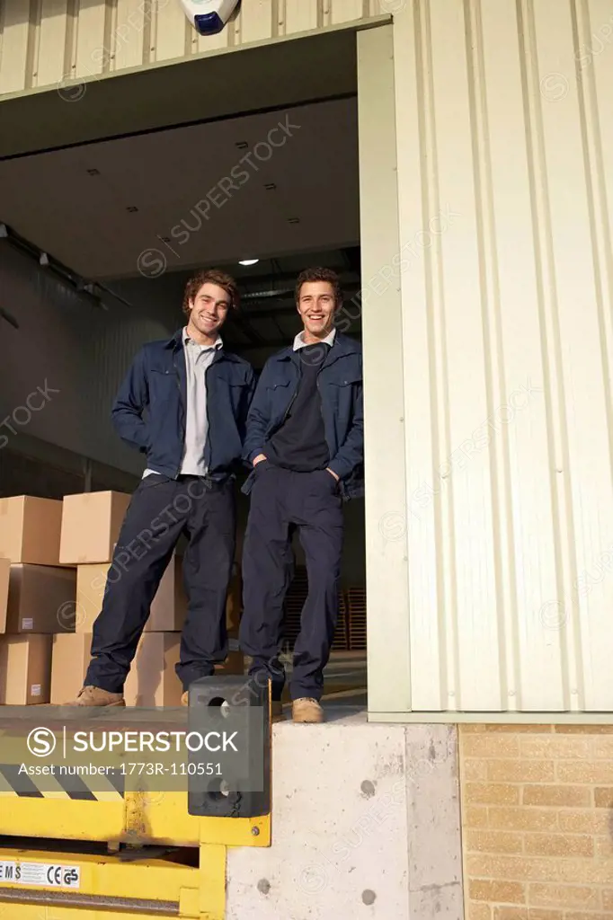 Two workers in warehouse doorway