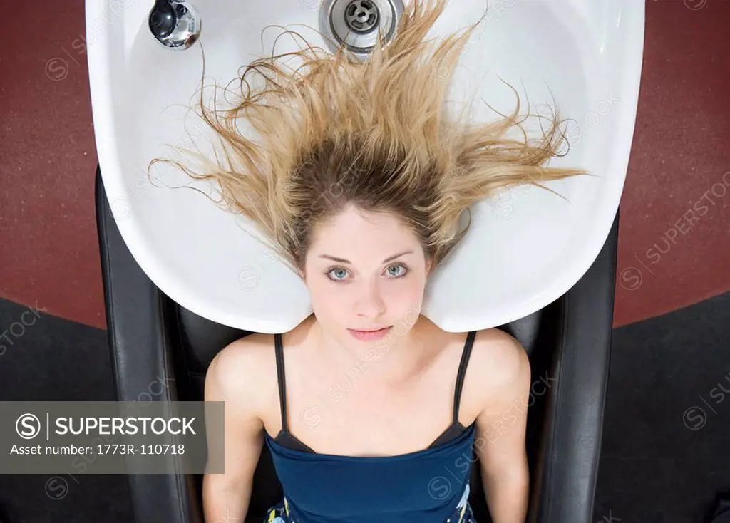 woman at sink at hairdressers