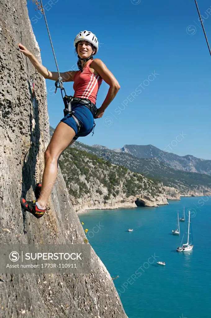 Woman rock climbing looking happy
