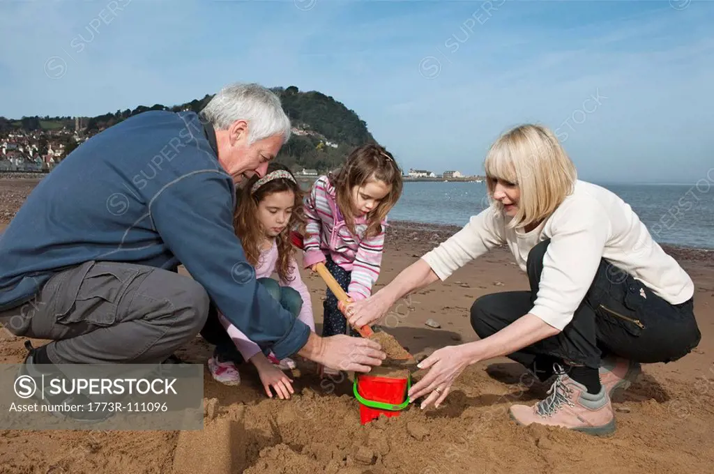 mature couple with children on beach