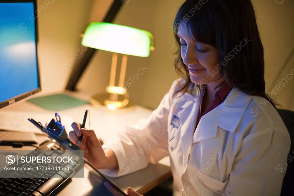 Female Doctor working at desk at night
