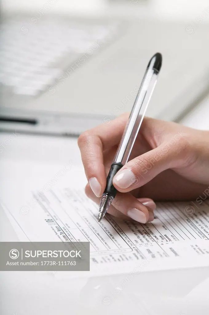 Woman filling out a tax form