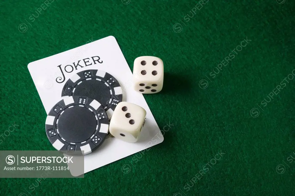 Joker card and gambling chips and dice