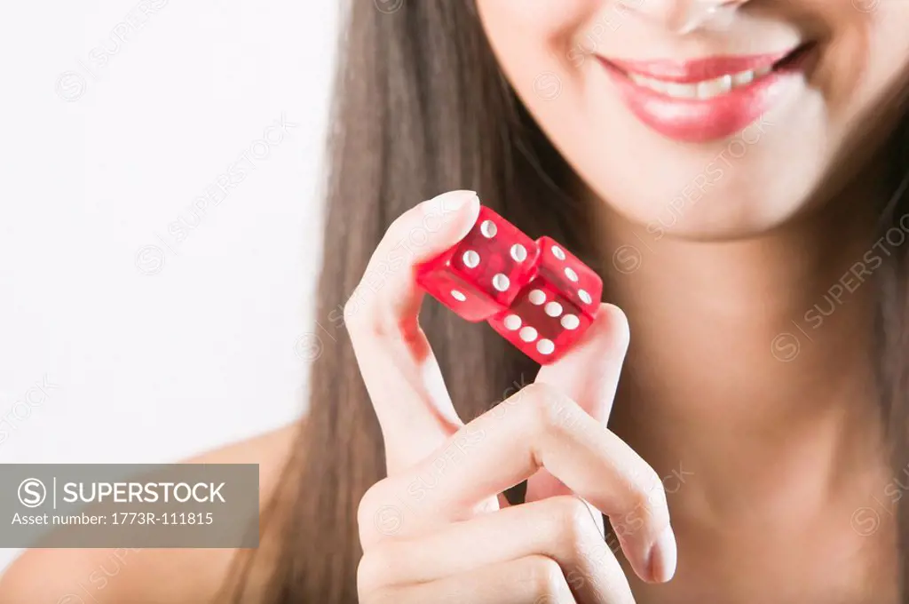 Woman holding red dice