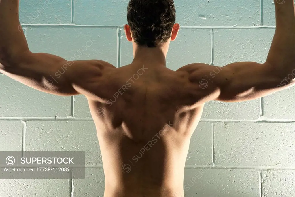 rear view of man flexing
