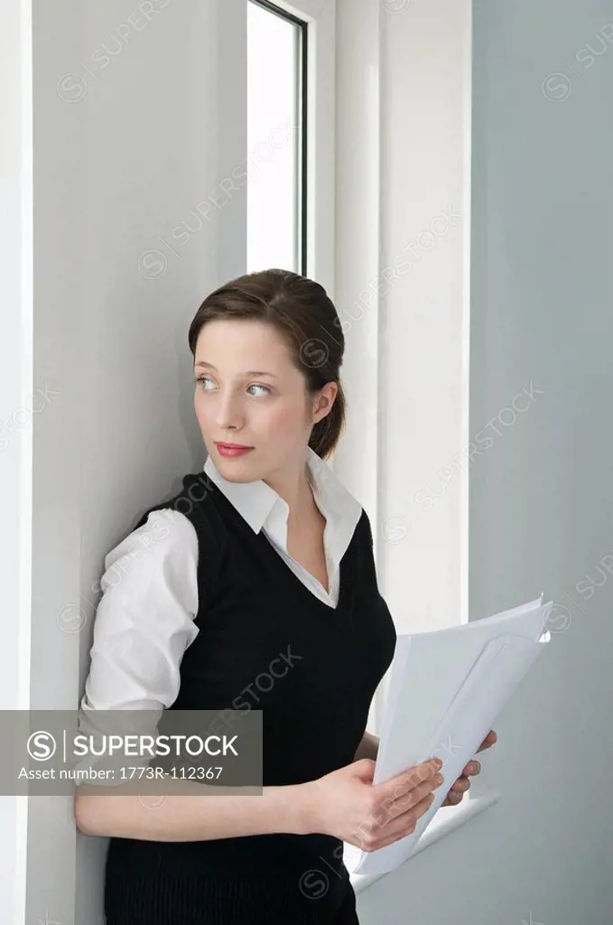 A businesswoman looking out of a window