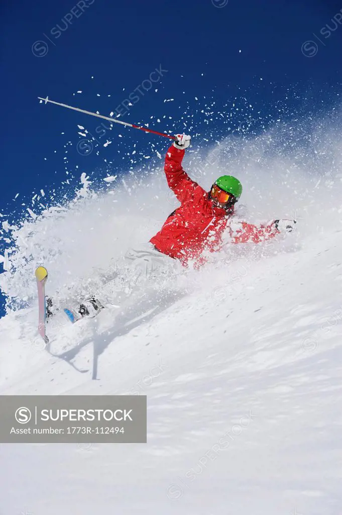 Man in red falling mid carve off_piste.