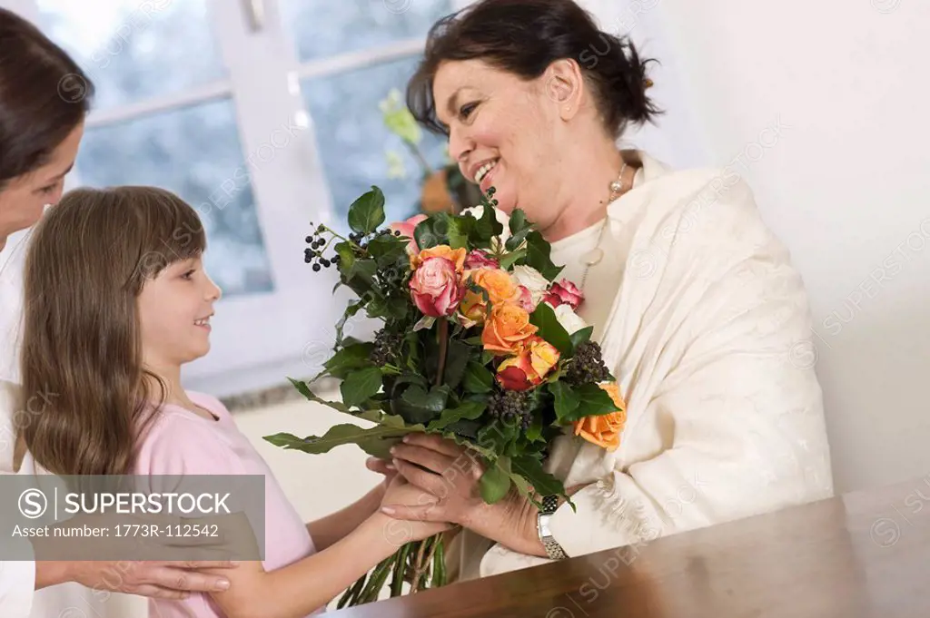 Child giving her grandmother flowers