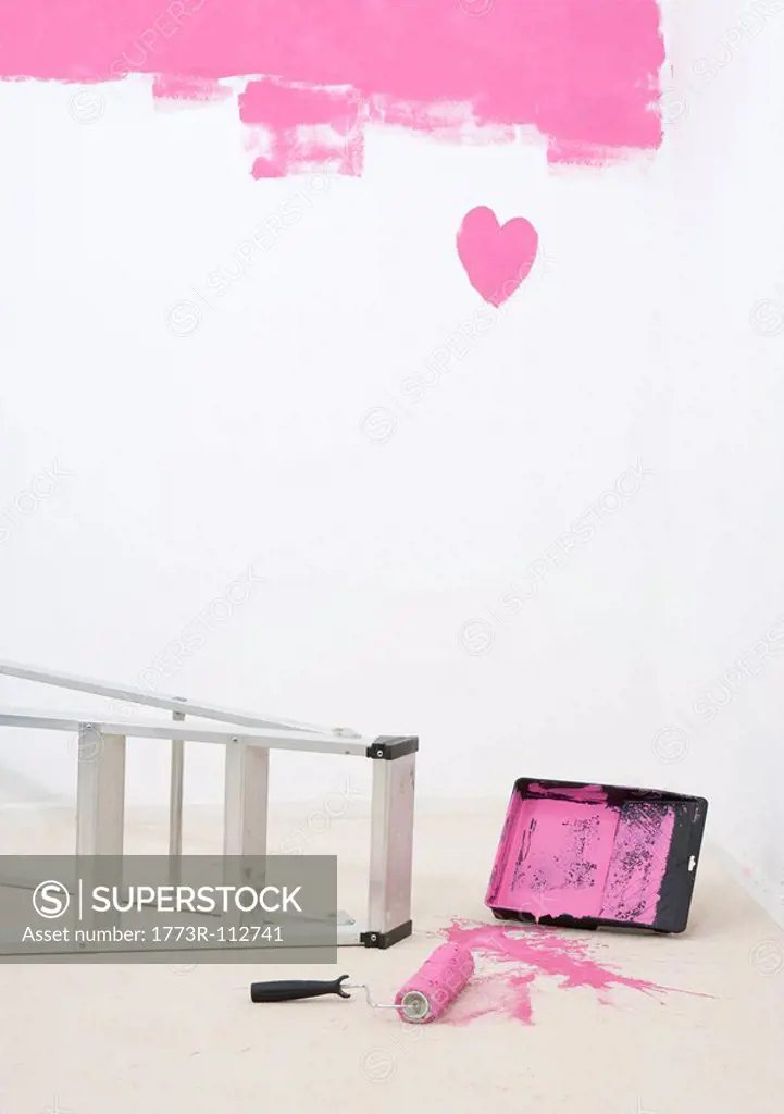 painted heart on wall and spilt paint