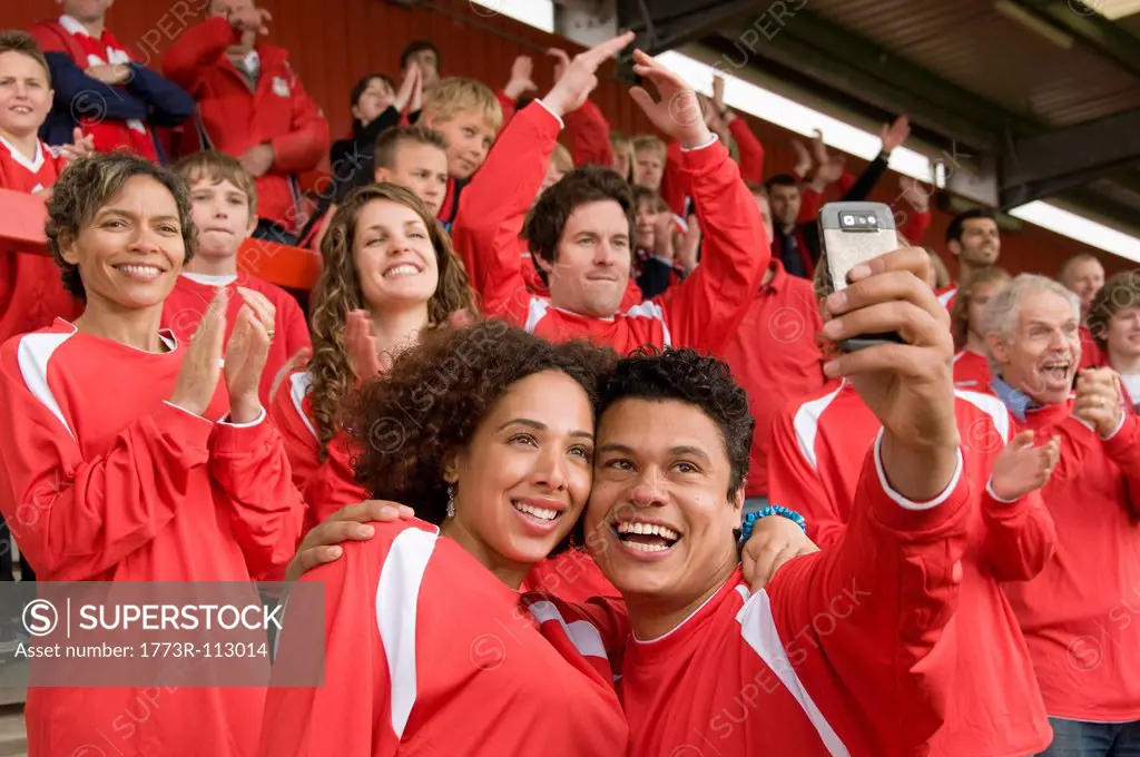 Football fans photographing themselves