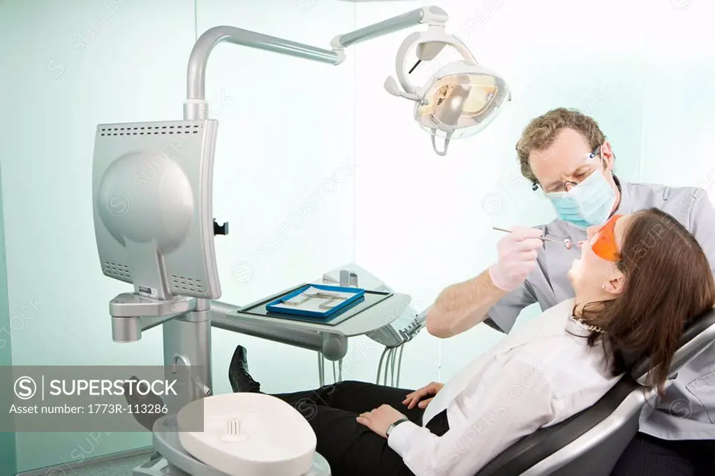 A dentist in surgery examining a patient