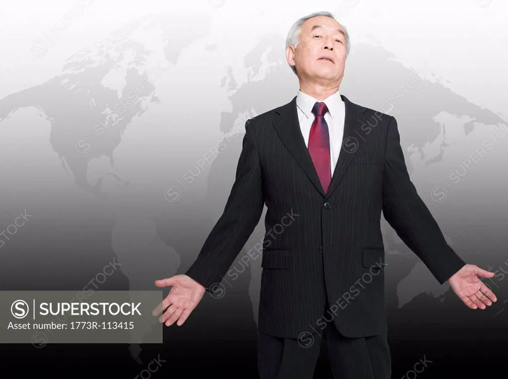 Asian man standing in front of world map