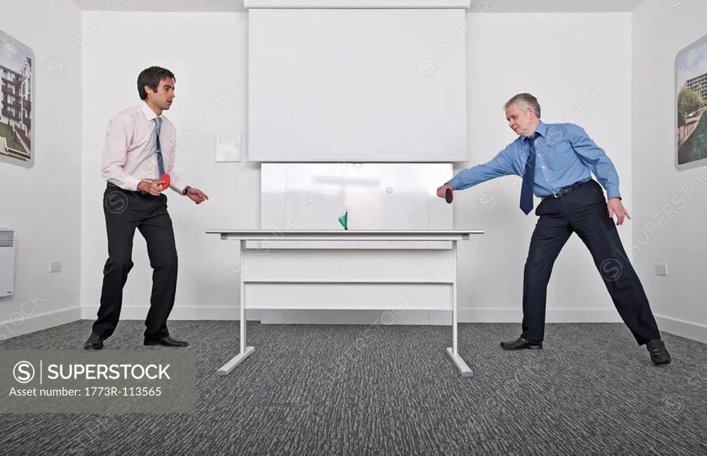 business men playing table tennis