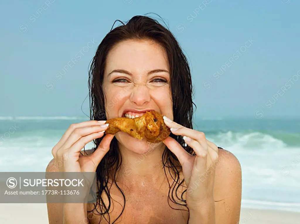 Young women eating a chicken leg