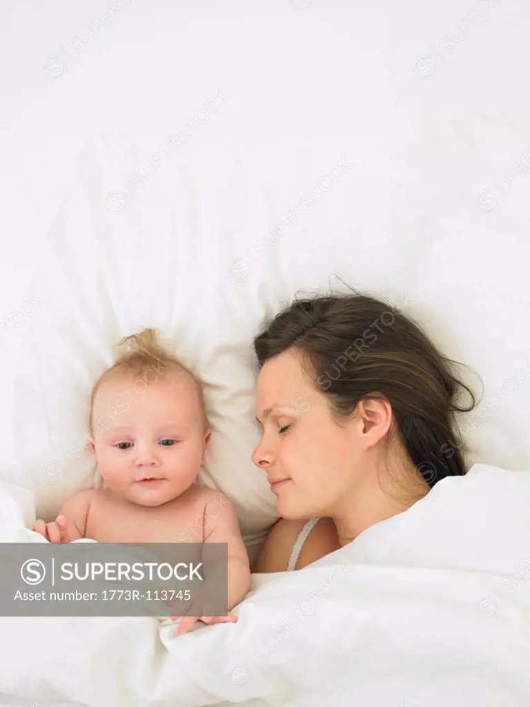 baby and mother in bed