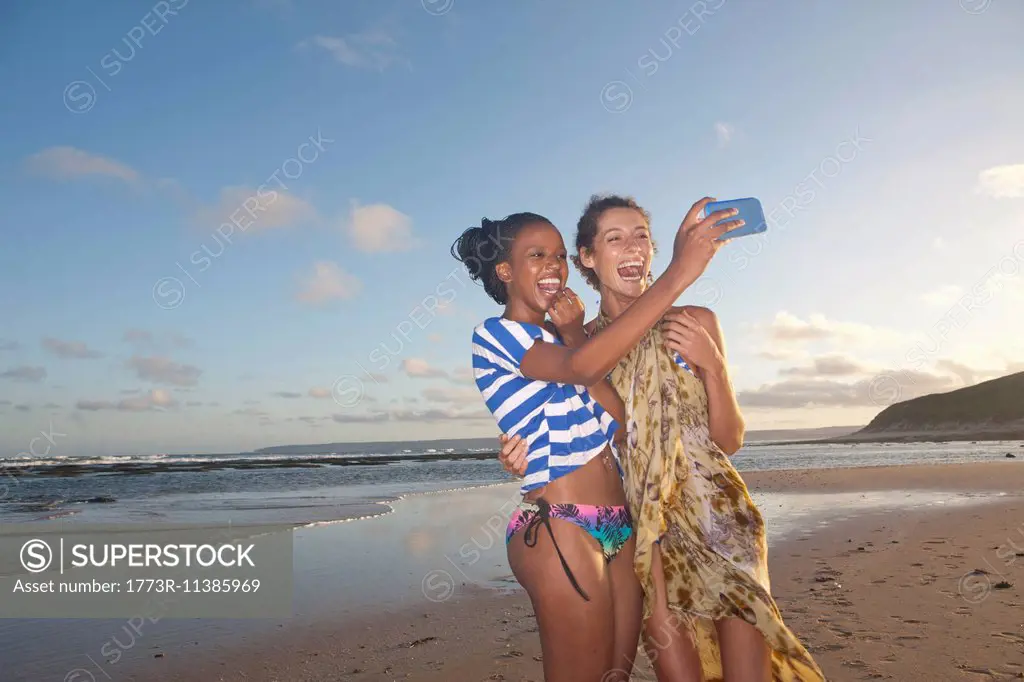 Friends on beach taking self portrait photograph