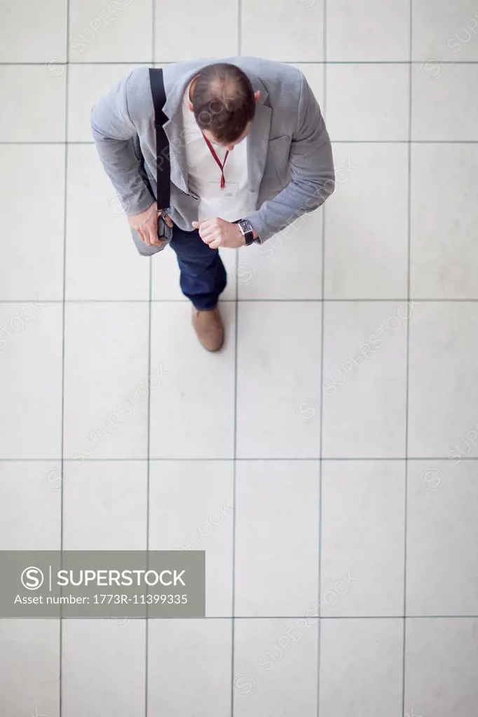 Overhead view of businessman walking through conference centre atrium