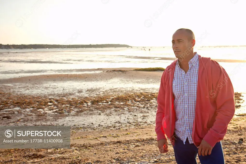 Man looking into distance on beach