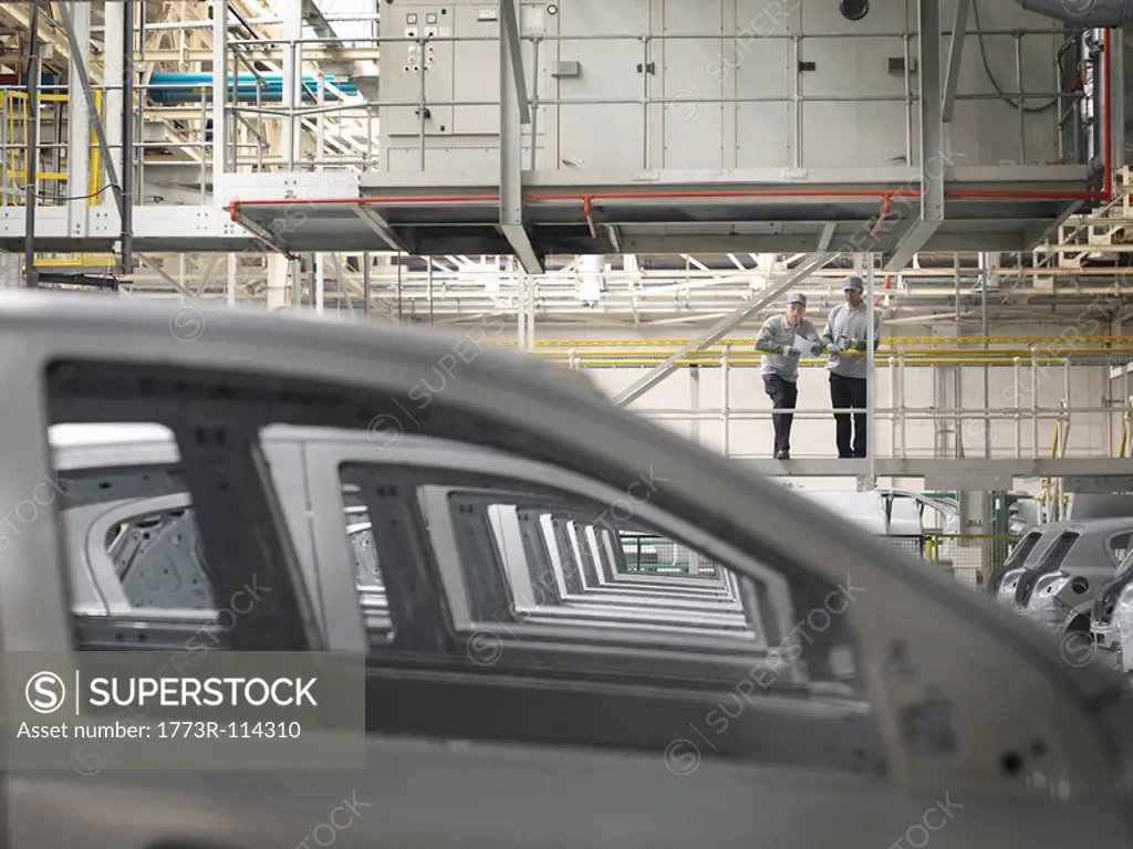Car Plant Workers Observing Cars